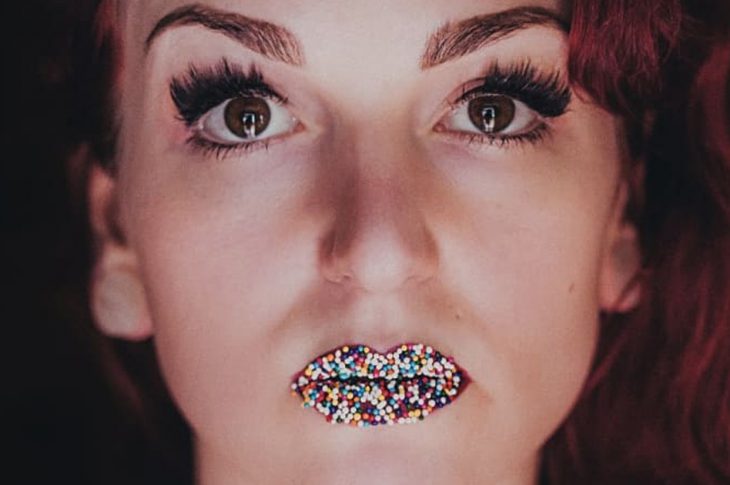 Photo of Renée Coolbrith with candy on her lips
