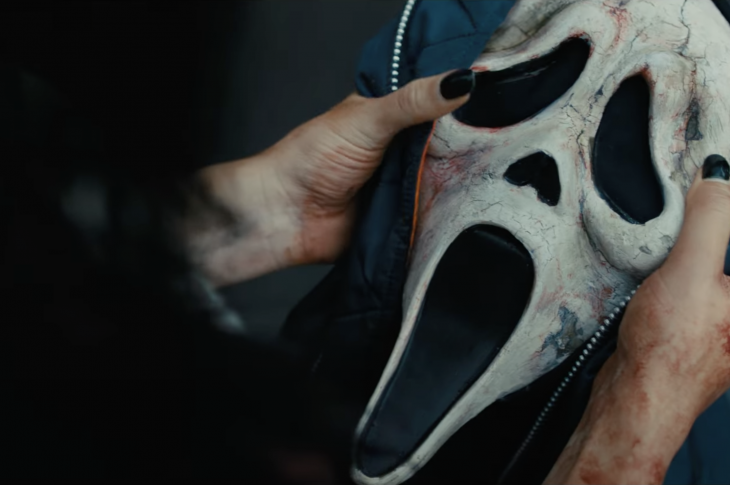 Bloody hands holding the Scream Ghostface mask. Scream VI image from YouTube