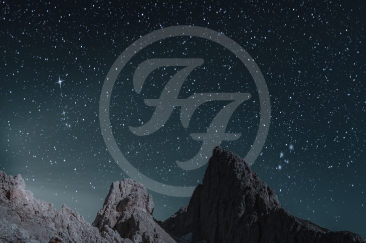 Foo fighters logo in stars above a mountain range.